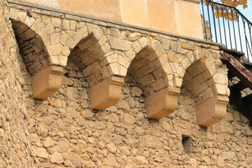 Detail of the stone arches supporting the defense corridor of the castle. The ruins of the castle...
