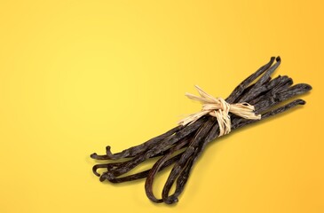 Dry brown aroma vanilla beans on the yellow desk