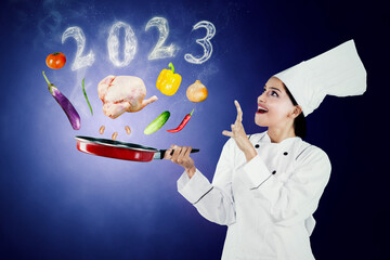 Female chef cooks with fly foods and 2023 numbers