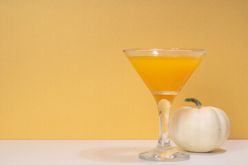 Halloween, Thanksgiving or fall cocktail pumpkintini cocktail. Sweet pumpkin martini, festive seasonal drink with cinnamon and pumpkin pie spices