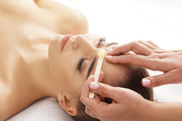 Hair removal, beauty and health concept. A young girl is getting an epilation procedure. A...