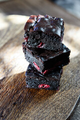 Pieces of homemade chocolate brownie with cherries. Delicious summer dessert. Selective focus. Hard lighting - 535561509