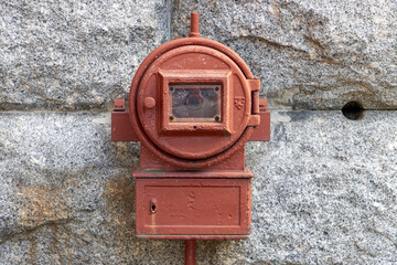 Old fire alarm on outdoor wall