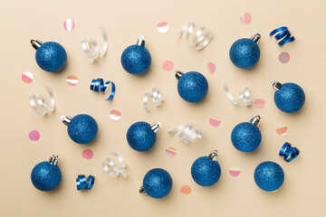 Christmas balls on color background, top view