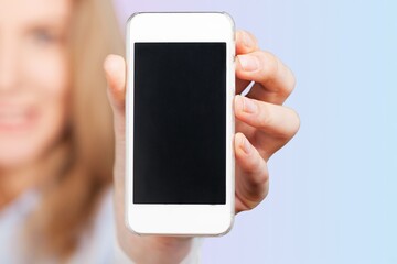 Beautiful woman holding blank screen smartphone