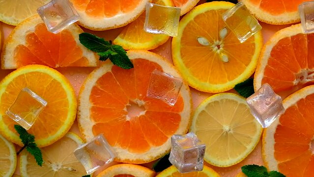 Citruses and ice on a yellow background. Selective focus.