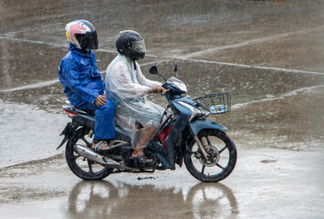 Obraz na płótnie Canvas Mototaxi is driving with a passenger in heavy rain
