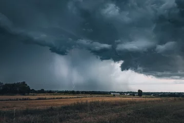 Fototapeten A huge storm cloud with a wall of rain in the countryside. © RafalDlugosz