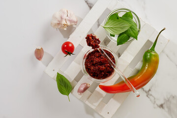 Spicy seasoning of Georgian cuisine adjika in a glass bowl