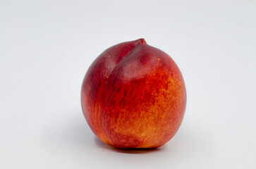 Red colored nectarine. Red nectarine fruit isolated on white background.
