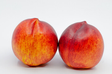 Red colored nectarines. Red nectarine fruit isolated on white background.
