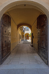 Fototapeta premium Picture along an old archway with pastel-coloured stone columns