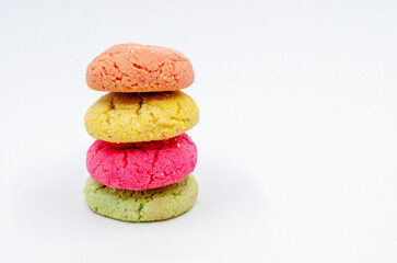 Colorful cookies stacked on top of each other. Colorful cookies on a white isolated background.

