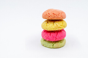 Colorful cookies stacked on top of each other. Colorful cookies on a white isolated background.
