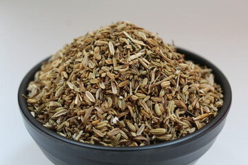 Dried granules of Aniseed, or Pimpinella Anisum seed, or Adas Manis, inside a bowl