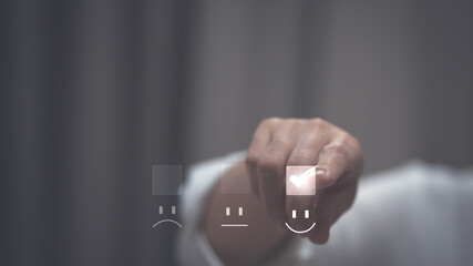 Customer service and Satisfaction concept ,Business people are touching the virtual screen on the happy Smiley face icon to give satisfaction in service. rating very impressed