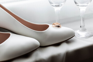 Wedding rings and shoes of the bride
