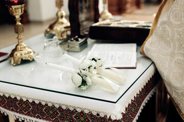 candles on a table in an embroidered tablecloth in a church