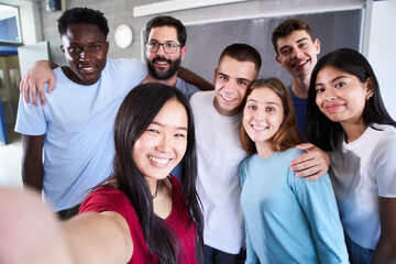 Portrait of a cheerful multiracial group of friends taking a selfie - New concept of normal...