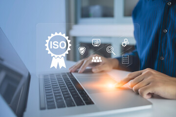 ISO Certification of standards quality control assurance business technology concept. Businessman using virtual screen iso certification icon to guarantee.