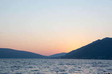 Seascape with mountains on sunset. A backing with sea and mountains for branding, calendar, postcard, screensaver, wallpaper, poster, banner, cover, website. A place for your design or text