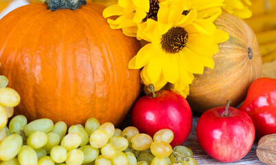 Festive Thanksgiving Composition with seasonal vegetables, fruits and flowers. Close-up. Selective focus.