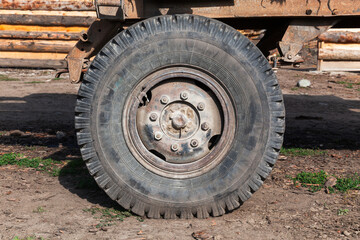 Fototapeta na wymiar Old rusty truck wheel close up photo