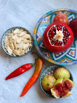 Colorful still life with fresh fruit. Pomegranate close up photo. Israeli food on a table. Eating fresh concept. 