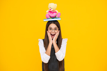 Back to school. Teenager schoolgirl hold toy. School children with favorite toys on isolated yellow studio background. Excited face, cheerful emotions of teenager schoolgirl.