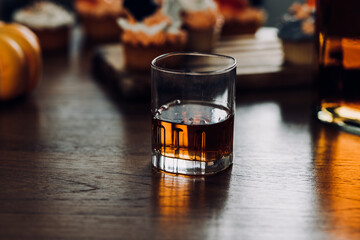a glass of whiskey and wine on the bar.	