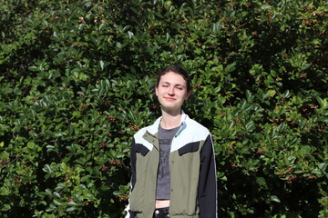 portrait of a cute girl on a background of trees