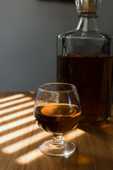 a glass of whiskey and wine on the bar.	