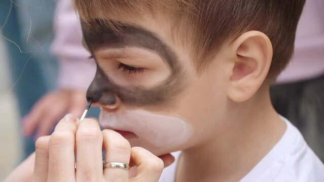 The boy is painted on the face