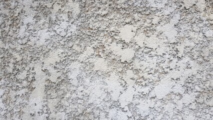Rough surface plaster wall painted white.
