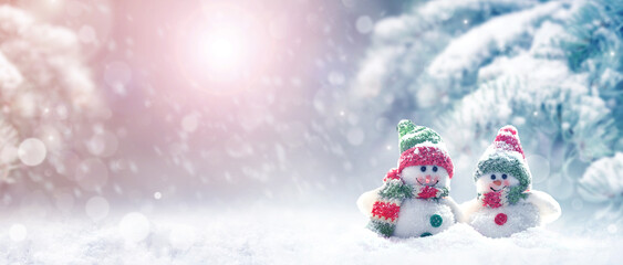 Merry Christmas and happy New Year greeting card with copy space.Two snowmen standing in snow....