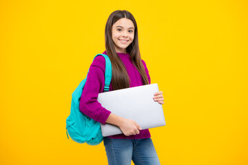 Fototapeta premium Teen schoolgirl hold laptop on isolated studio background. Cchool student learning online, webinar, video lesson, distance education.