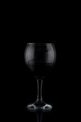 glasses of red wine on a black background with reflection