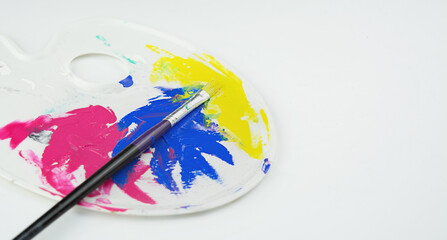 A palette with farbs and pens on a white background. Side view. Banner. Space copy.