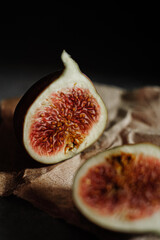 Fig cut in half on parchment, black background