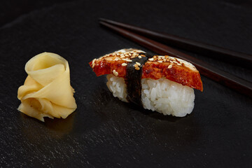Delicious Unagi Eel Nigiri Sushi Eel Sushi on black background. Traditional Japanese cuisine
