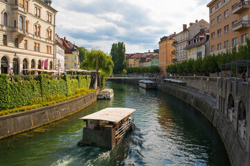 Tourist boats pass along the Ljubljanici River in central Ljubljana, Slovenia
