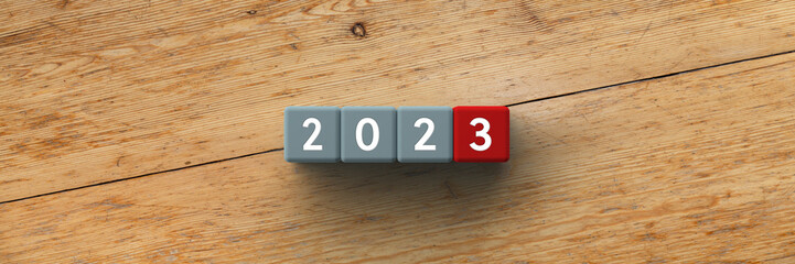 3D Cubes with the year 2023 on a wooden background	

