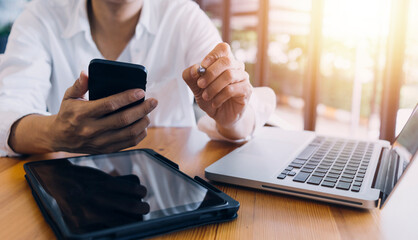 Business partnership coworkers using a tablet to analysis graph company financial budget report and cost work progress and planning for future in office room.