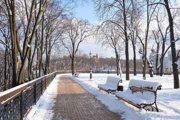 snow covered bench in a park