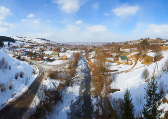 Obraz premium Rural alpine winter landscape with fence and path