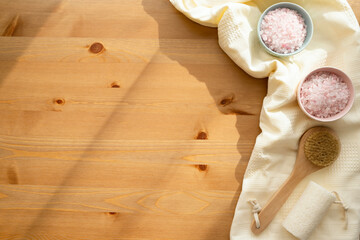 Sea salt for the bathroom on the table, natural eco-friendly washcloth and body brush. Free space.
