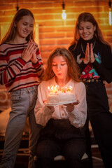 Girlfriends celebrate birthday in a cafe and have fun.