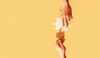 Closeup hands of man connecting jigsaw puzzle. Business solutions, success and strategy concept