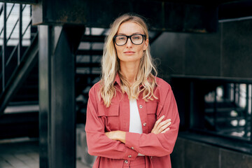 Portrait of a modern attractive confident business woman in glasses and a business suit.