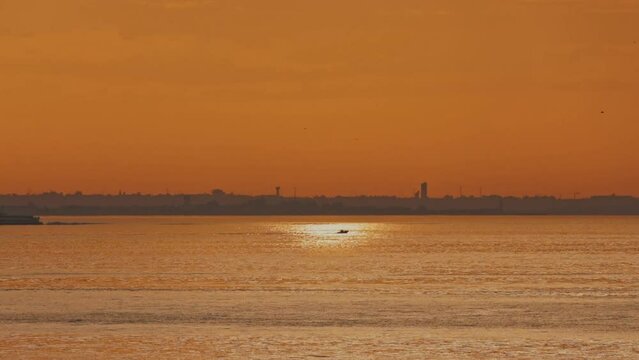 River boat on ocean water at sunrise, vapour cross the river tejo at the morning